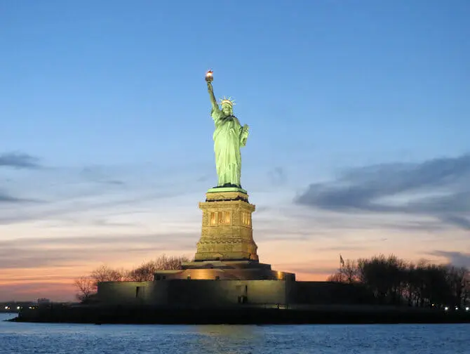 Statue of Liberty by sunset during a boat tour New York